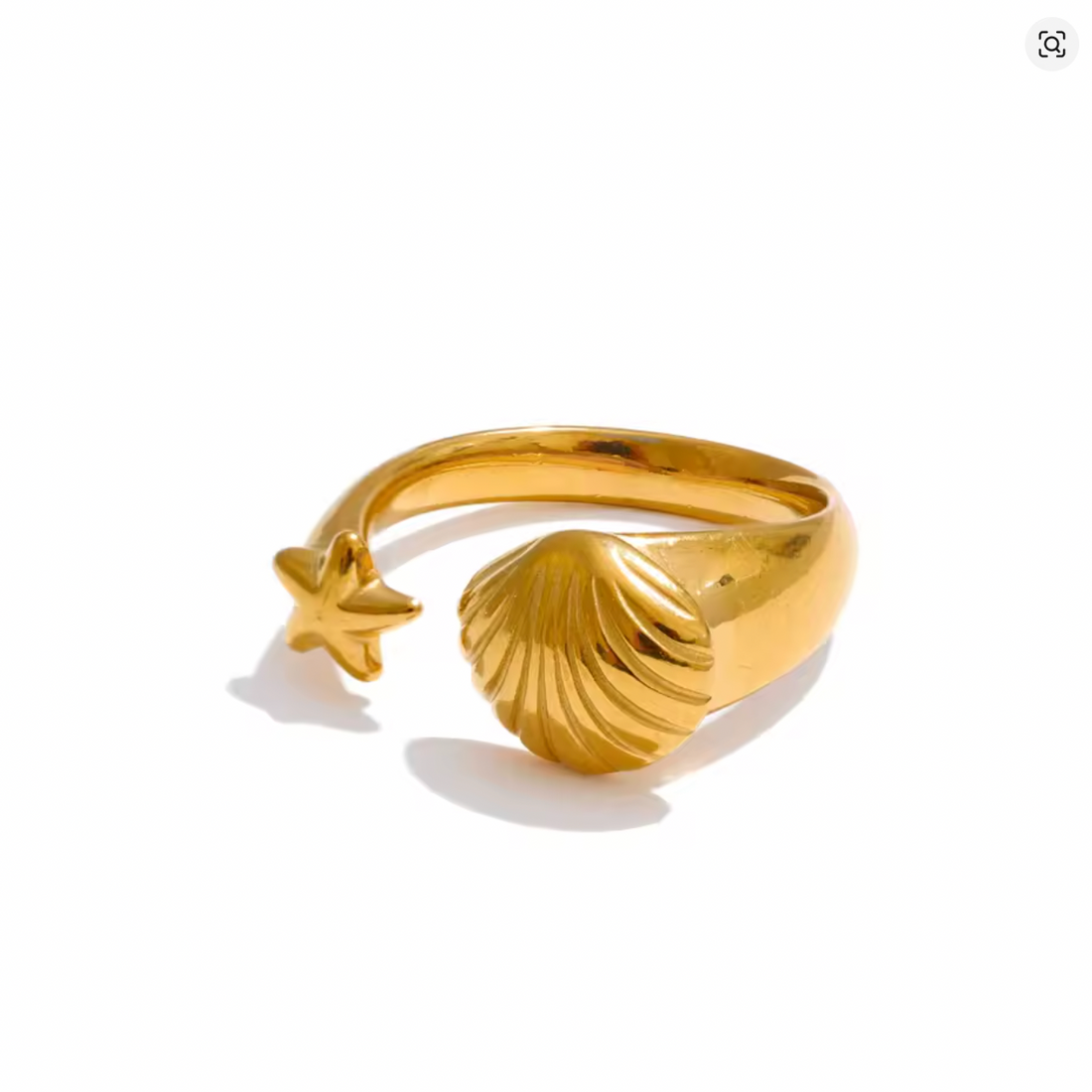 Gold ring with shell and starfish design on a white background