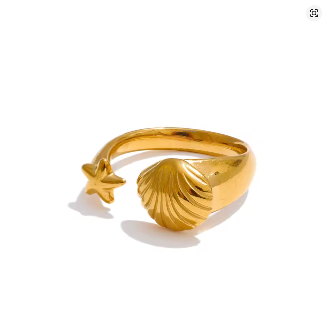 Gold ring with shell and starfish design on a white background