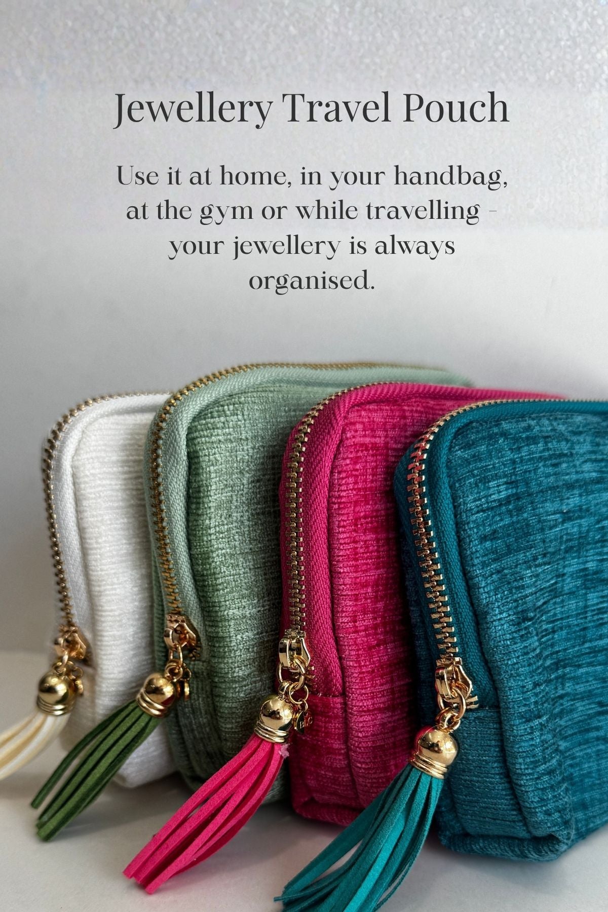 Four jewelry travel pouches in different colors with tassels on a light background.